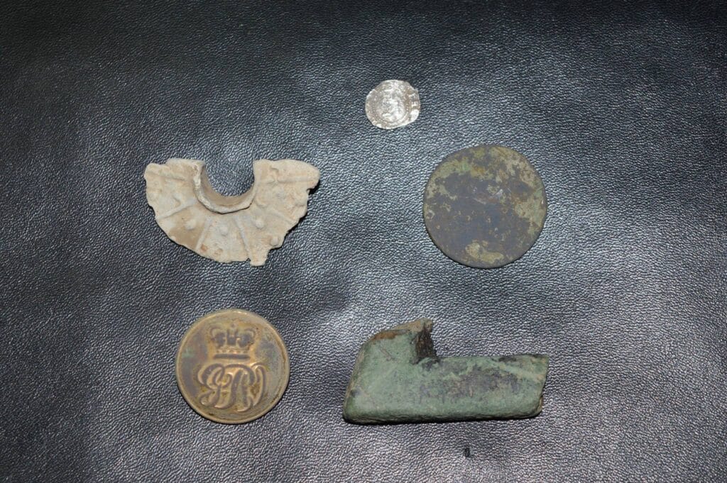Tiny hammered, spindle whorl, nice button and a coin, not sure if it is a half penny